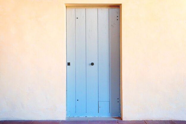 Old ancient front door to house with porch