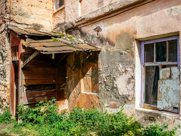 Old apartment building. Crumbling plaster on the walls of the house