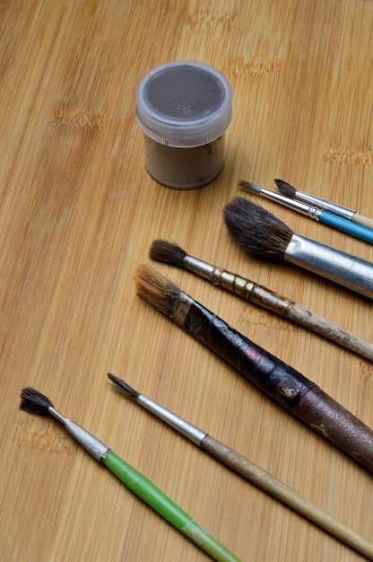 old art brushes on a wooden surface. close-up.