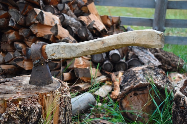 Old axe with wooden handle on stub