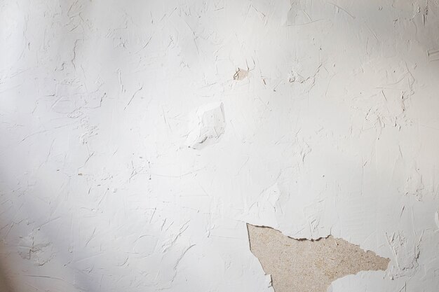 Old background of white cement surface with cracks