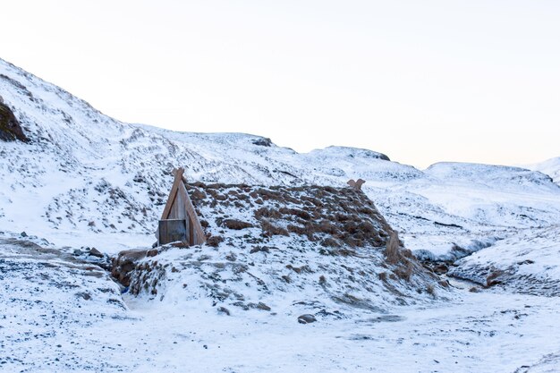 An old bathhouse with a hot spring in the mountains of Iceland. Iceland winter landscape