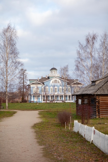 An old beautiful mansion with a wooden veranda, built in the 19th century. A big old house