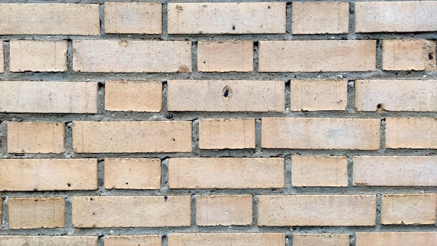 Photo old beige brick wall background texture close up