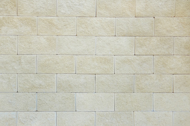 Old beige stone wall background texture