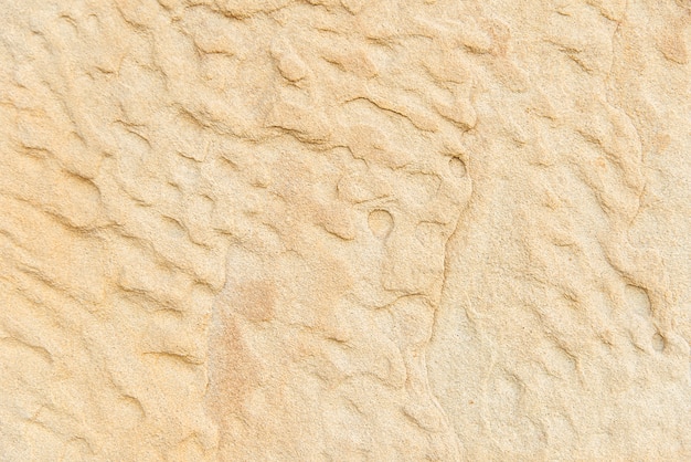 Old beige stone wall background texture