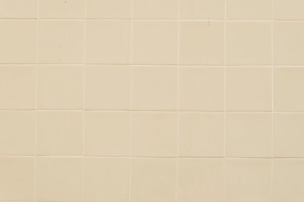 Old beige tile wall background