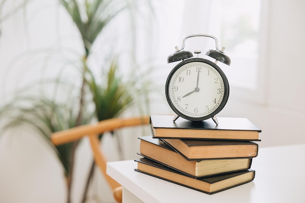 Old bell clock on stack books times for learning reading education remind concept