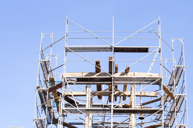 Photo the old bell tower. restoration of the old bell tower. scaffolding. old bell