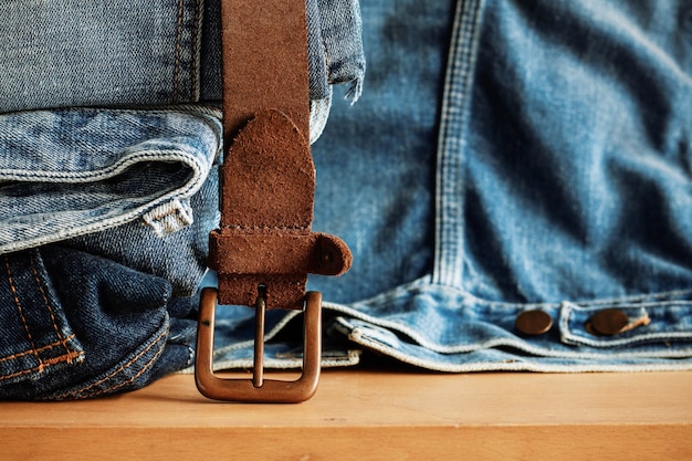 Old belt and jeans on wooden.