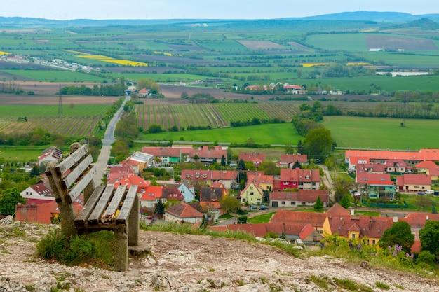 An old bench on a hill overlooking a small town