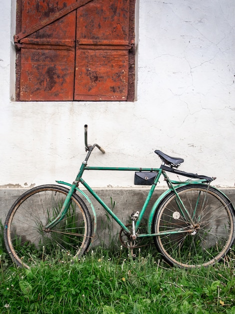 Old bike on the background of the wall