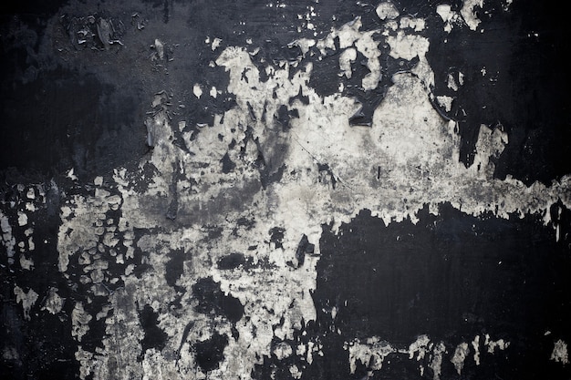 Old black paint texture peeling off concrete wall background