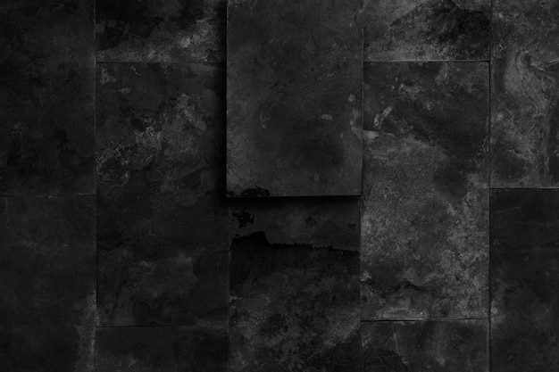 Old black stone wall. Dark grunge background