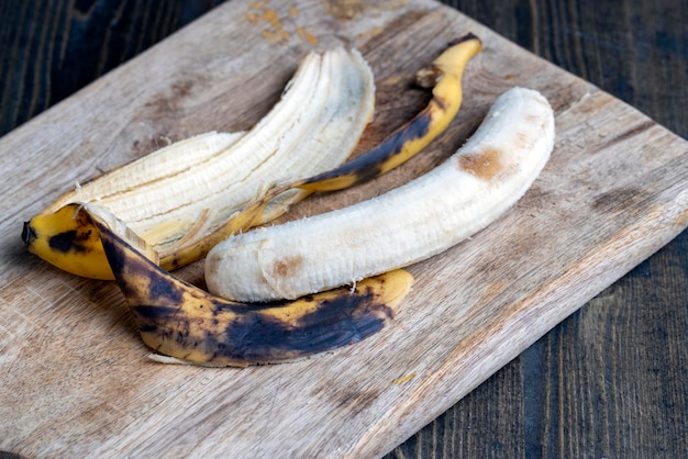 Old blackening banana on a cutting board perishable banana fruit food