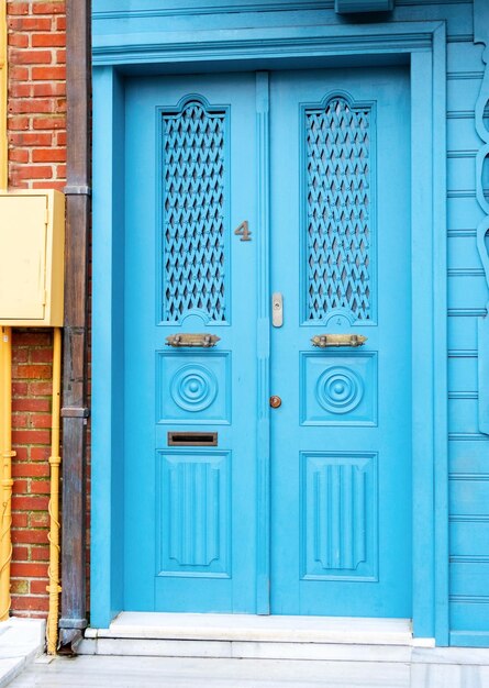 Old blue metal door with brick frame