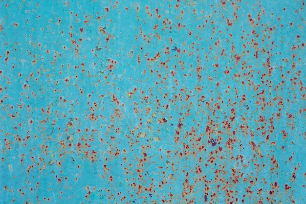 Old blue metal sheet with shabby paint - background or texture