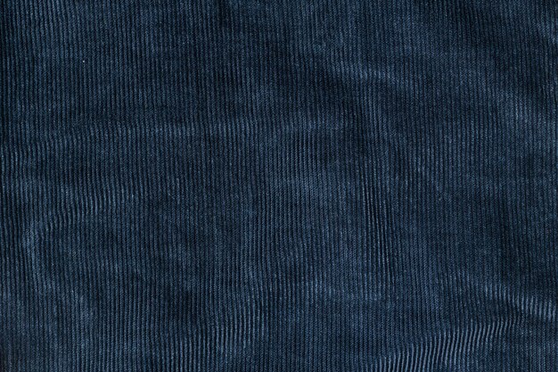 Старый синий ребристый фон текстуры вельвета. Концепция текстуры вельветовой ткани