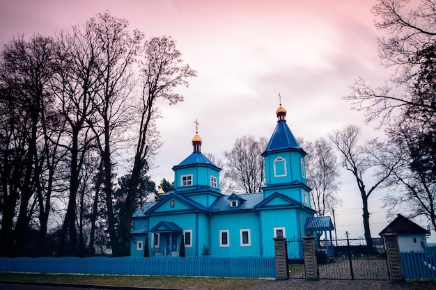 The old blue Ukrainian church against the background of a blurred sky