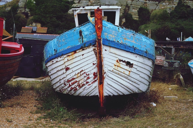 Old boats moored on field