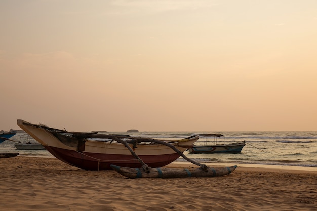 Old boats on the ocean at sunset 