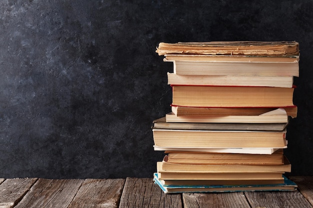 Old books in front of classroom chalk board