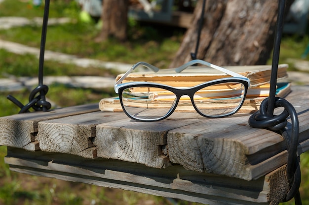 Old books and glasses on a homemade swing