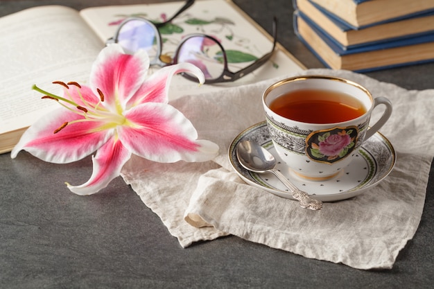 old books and mail with antique cup of tea