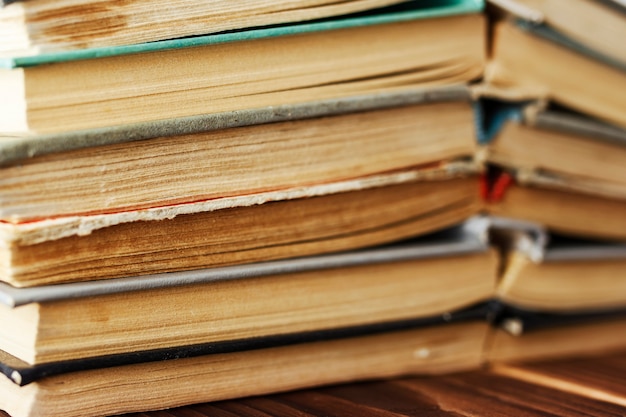 Old books stacked in a pile. Toned photo