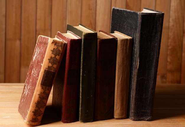 Old books on table on wooden background