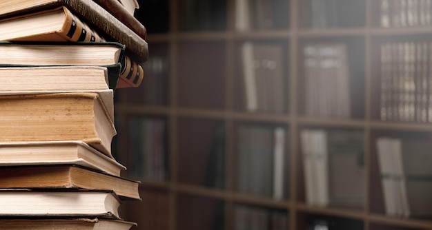 Old books on wooden shelf and ray of light.