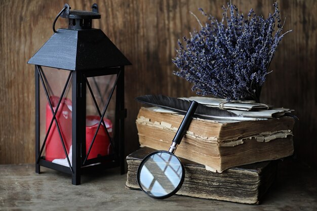 Old books on a wooden table and glass magnifier