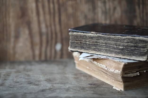 Old books on a wooden table and glass magnifier