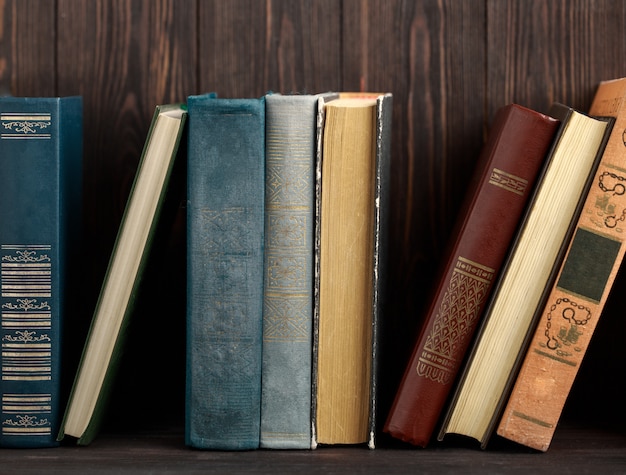 Old books on wooden table. The source of information