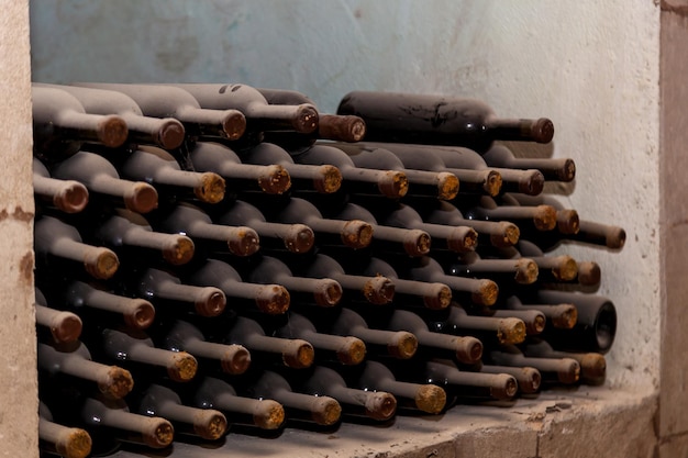 列に積み上げられた古いワインのボトル
