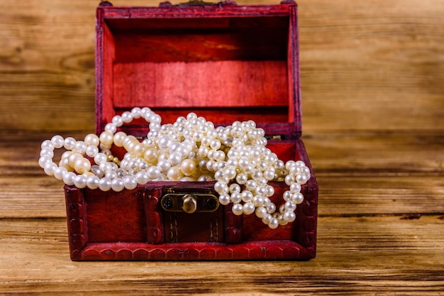 Old box of red wood full of the jewelry Treasure chest