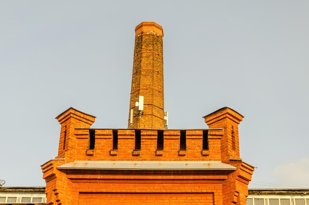 An old brick chimney on a sunny day.