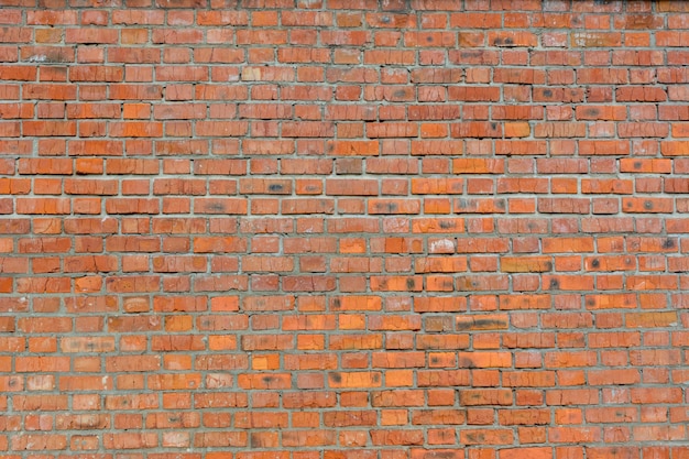 Old brick wall of red color, panorama of masonry. Texture background. Close-up.