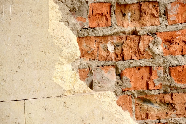 Old brick wall with horizontal half chipped white tiles