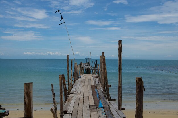 Old bridge on beach and blue sky view