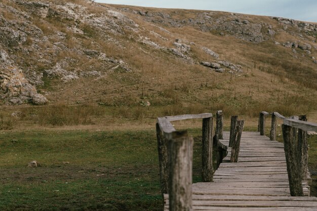 old bridge from boards in a field near the Moldavian mountains of rocks in the north of the country