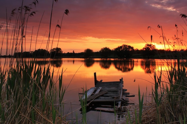 Old bridge on sunset on the lake