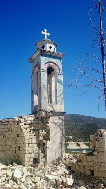 Old broken church steeple against sky