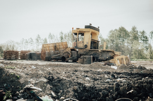 Old broken compactor at a landfill