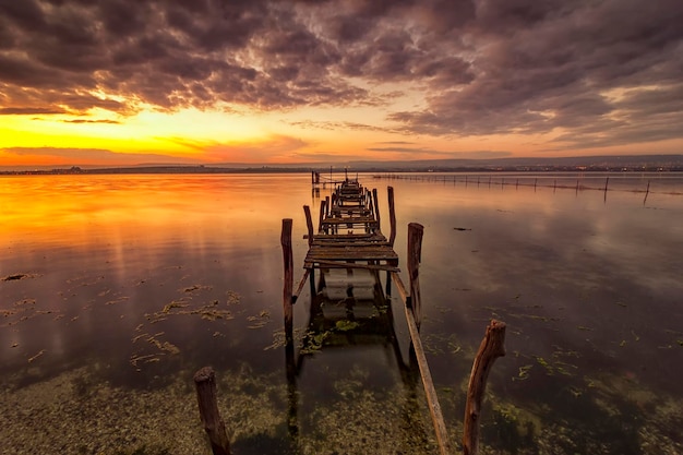 Old broken pier after sunset