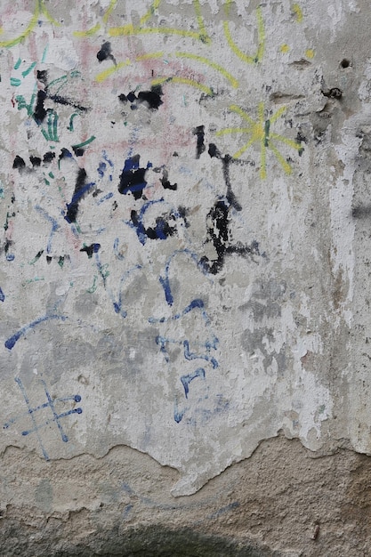 an old broken wall with paint peeling off