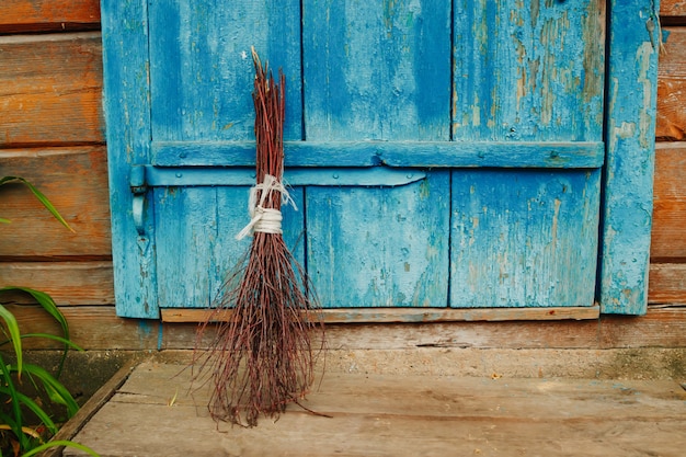 An old broom on the wooden door