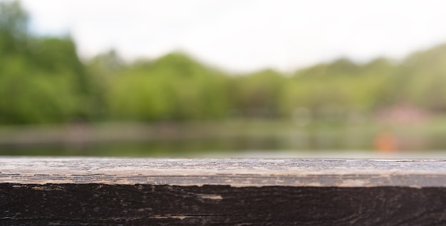 Old brown board on the lake background