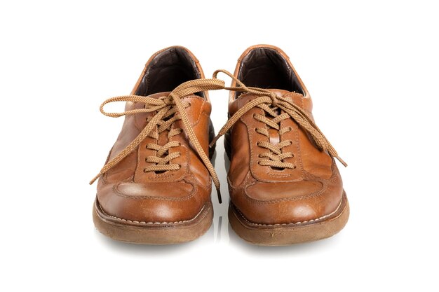 Old brown leather shoes for men over white background