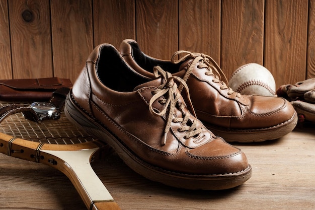 Old brown leather shoes for men on wood background